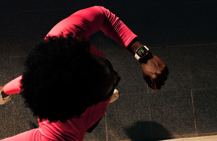Photo of a man using his Apple Watch to track his run