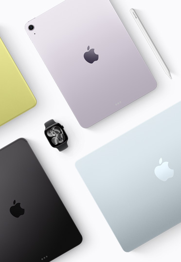 Draufsicht auf Mac und iPad Geräte verschiedener Farben mit einer schwarzen Apple Watch in der Mitte.