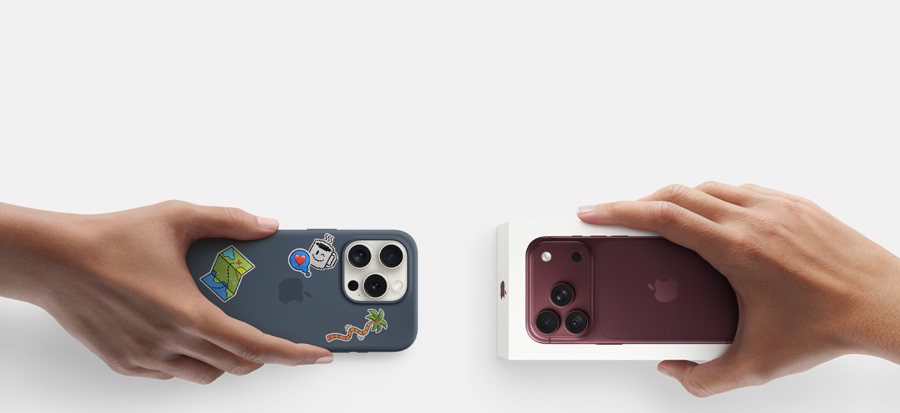Due mani che si scambiano un iPhone 17 Pro usato color argento con custodia in silicone coperta di adesivi sul retro e un iPhone 18 Pro nuovo borgogna (rosso scuro) ancora nella confezione.