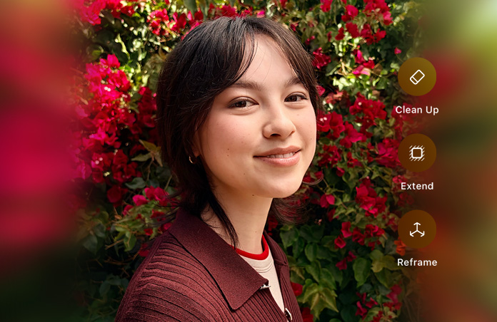 Photo d’une personne souriante aux cheveux bruns, portant un pull marron, entourée de fleurs rouges, démonstration de retouche photo par IA avec les options Correction, Étendre et Recadrer affichées sur la photo